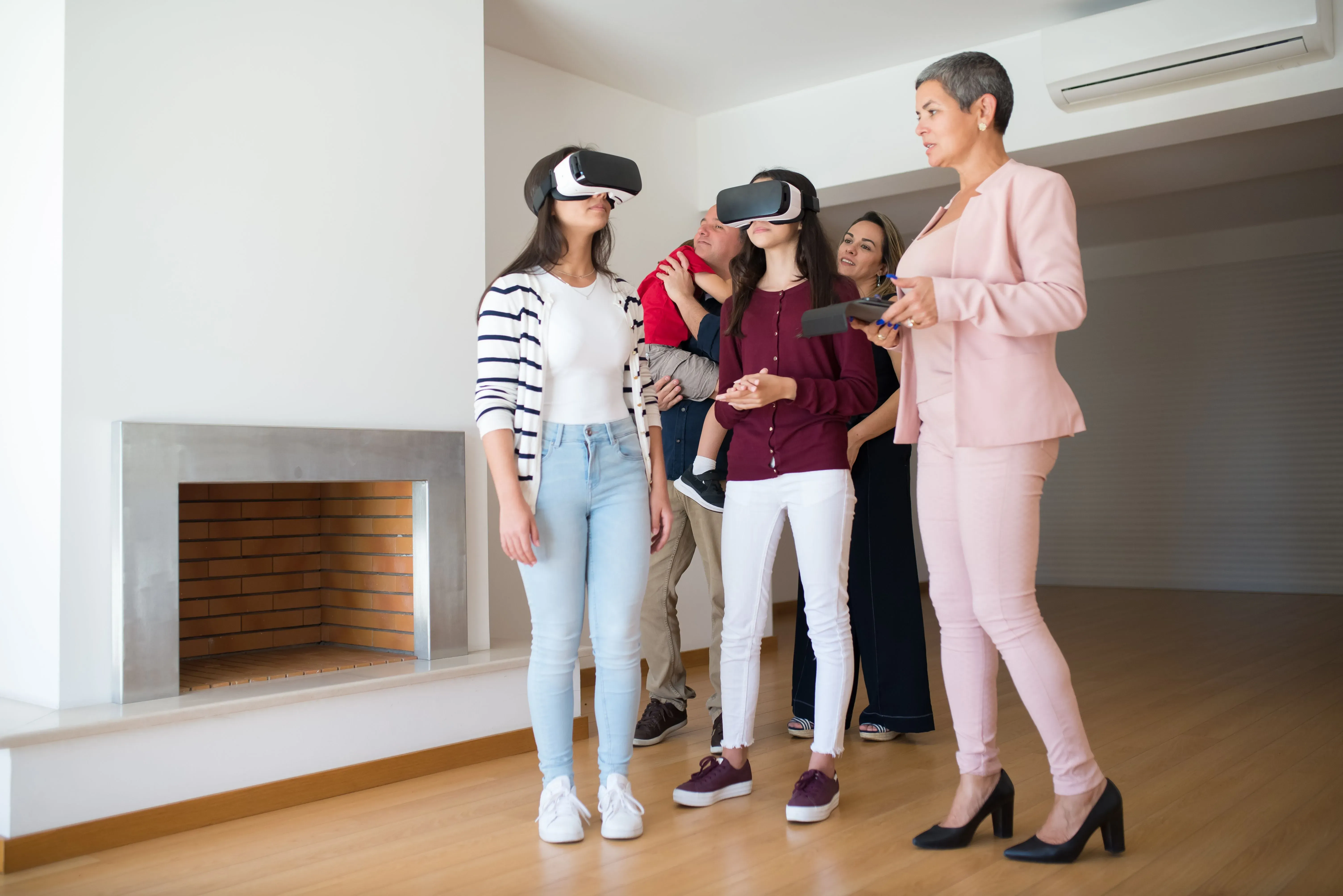 Family experiencing virtual reality house tour with real estate agent